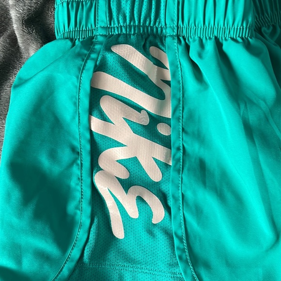 Teal Nike shorts with pink Nike sign and script down right side - Picture 2 of 3